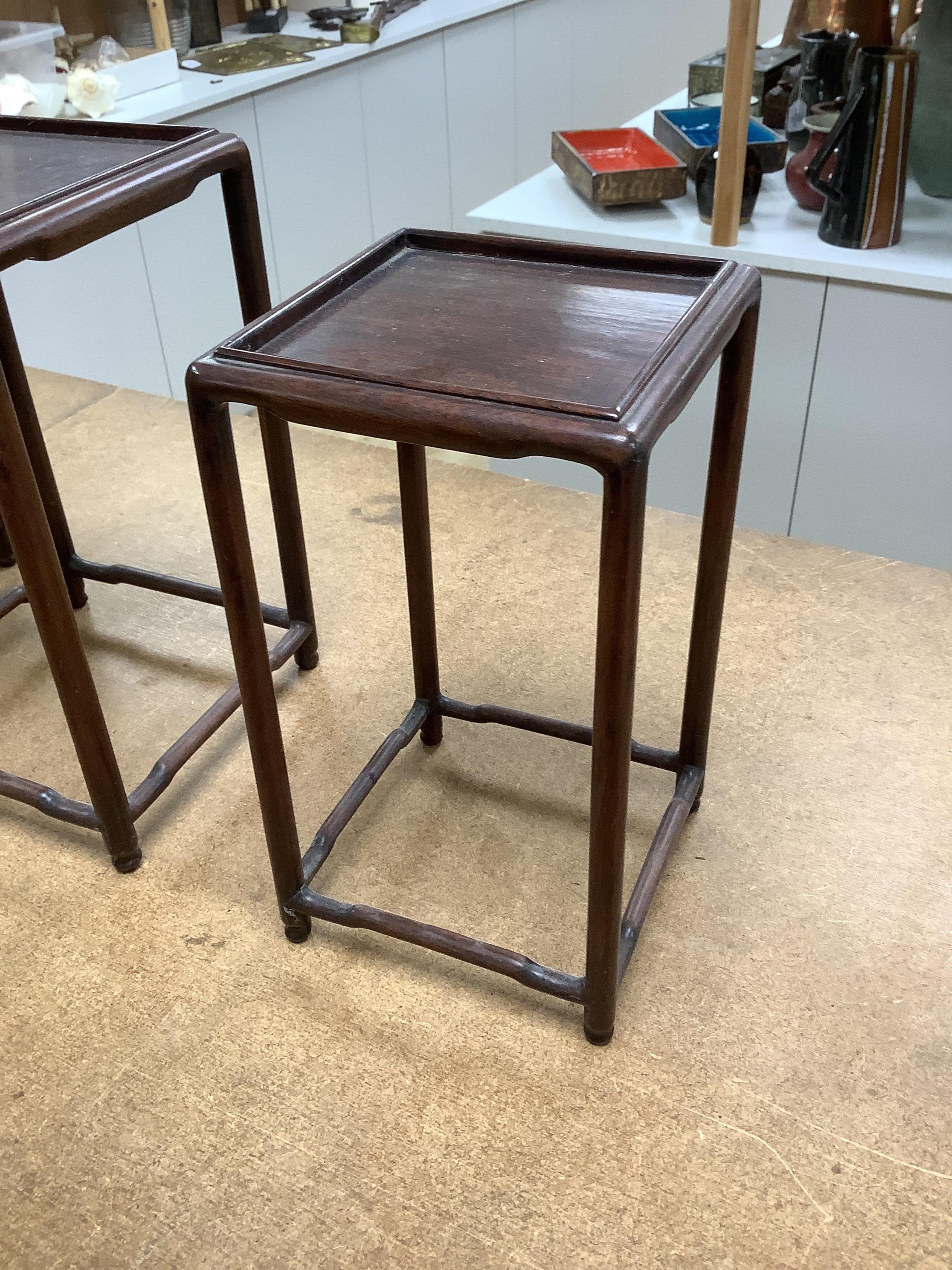 A nest of five Chinese hardwood stands, tallest (largest) 32cm high